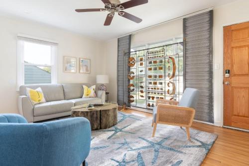 a living room with a couch and a table at Peaceful Gem HotTub Fenced Yard & Near Downtown in Omaha