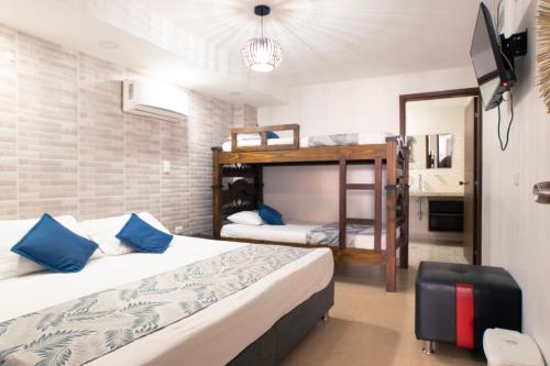 a bedroom with two beds and a bunk bed at Hotel Riviera Plaza in Bucaramanga
