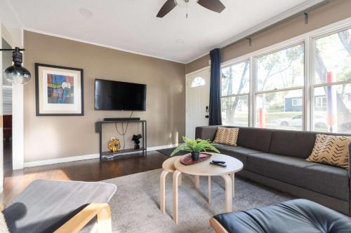a living room with a couch and a table at Enchanting 3BR Cottage Close to Downtown in Omaha