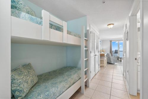 a bedroom with a bunk bed and a living room at Seychelles 1406 Free Beach Chairs in Panama City Beach