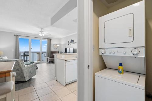a kitchen and living room with a view of the ocean at Seychelles 1406 Free Beach Chairs in Panama City Beach