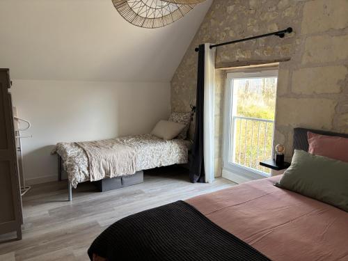 Ein Bett oder Betten in einem Zimmer der Unterkunft Gîte les Huttières