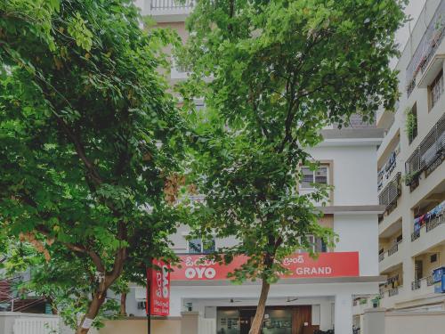 a building with trees in front of it at Super Hotel O Gokul Grand Near SR Nagar Police Station in Hyderabad