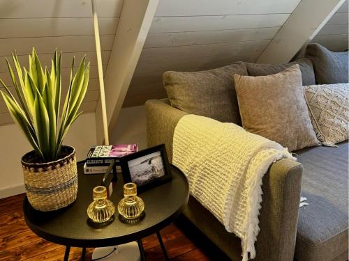 a living room with a couch and a table at Wisteria Österlen in Simrishamn