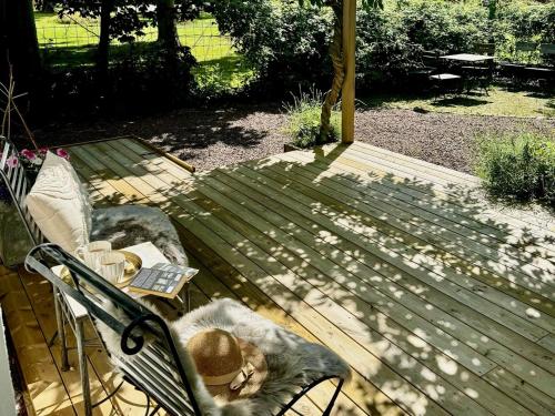 a cat sitting on a bench with a laptop at Wisteria Österlen in Simrishamn