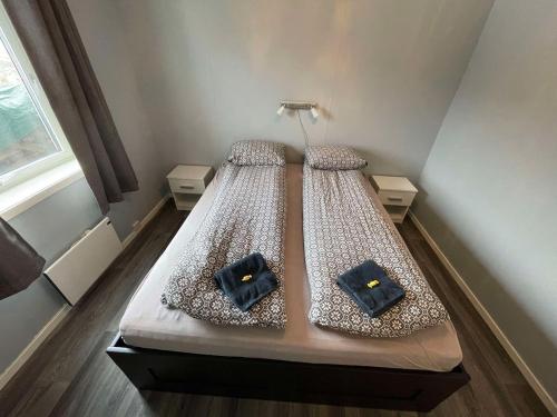 a bed with two pillows on it in a room at Leilighet i Sør-Fron kommune in Sør-Fron