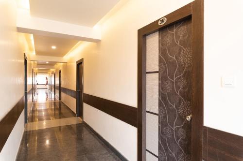 a corridor of a house with a door at Capital O Seatree in Visakhapatnam