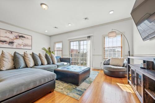 a living room with a couch and a table at HUGE Cozy Jersey City Oasis with Double Balcony - 20 mins to NYC in Jersey City