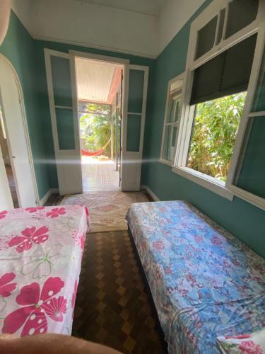 Ένα ή περισσότερα κρεβάτια σε δωμάτιο στο Villa Aruanda