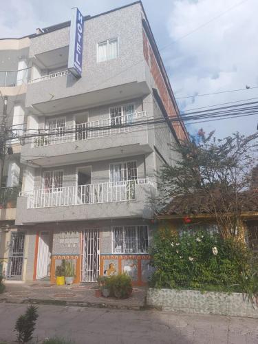 a building with a sign on the side of it at Hotel Los Colores GUATAPE in Guatapé