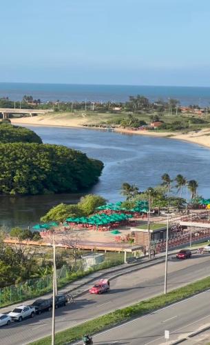 a river with cars parked on the side of a road at Casa China & Silva, Otima Casa para praia ou descanso, proximo as Dunas da Sabiaguaba e shoppings em Eusebio e Fortaleza Ce in Eusébio