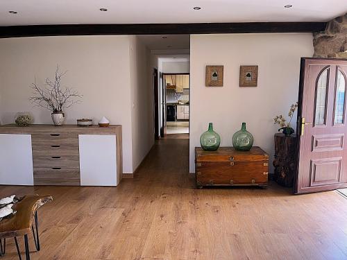 a living room with a dresser and a door at O Refuxio de Tebra in Tebra