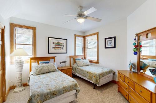 a bedroom with two beds and a ceiling fan at The Oaks #15-11 in Avon