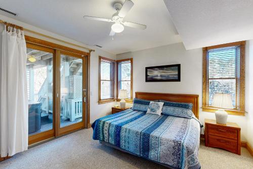 a bedroom with a bed and a ceiling fan at The Oaks #15-11 in Avon