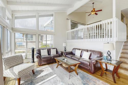 a living room with leather couches and a table at Hawaii Kai Dream in Honolulu
