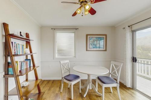 a dining room with a table and chairs and a ceiling fan at Hawaii Kai Dream in Honolulu
