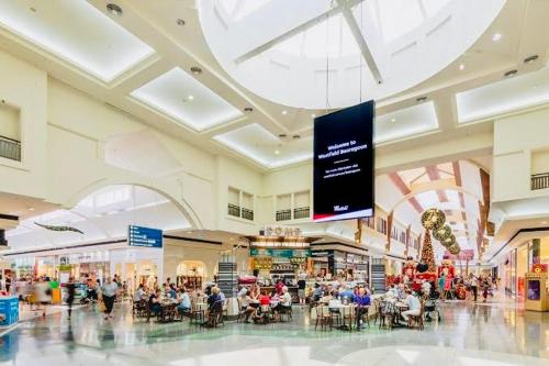 a large shopping mall with a large screen in it at Affordable Long-Term Stay ENS Master Bedroom in Perth Fremantle University Hospital in Perth
