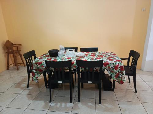 a dining room table with chairs and a tablecloth on it at Lobito in Puerto Baquerizo Moreno