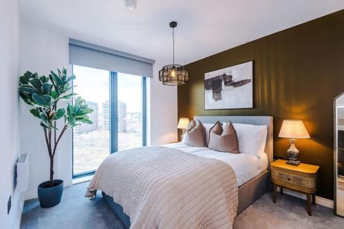 a bedroom with a large bed and a large window at Leeds City Centre - Luxury 2 Bed - Free Parking in Leeds