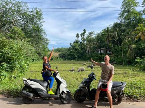 a man and a woman riding on a scooter at The Nonnas Privacy Villa in Beruwala