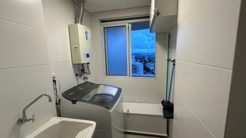 a small bathroom with a sink and a window at Condomínio próximo a ponte Hercílio Luz in Florianópolis