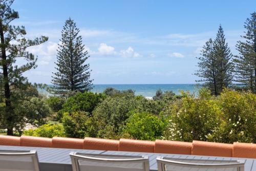 a balcony with chairs and a view of the ocean at Parkside on Plover Street in Peregian Beach