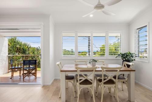 a dining room with a table and chairs at 1-5 Petrel Street Peregian Beach QLD 4573 in Peregian Beach