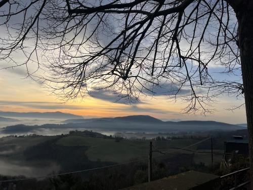 a view of a foggy valley at sunset at Il Palazzo del Borgo - Affittacamere in Todi