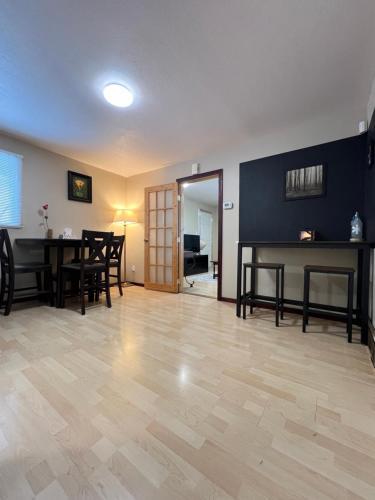 a living room with a table and a dining room at Moonlight Stay Whitehorse Downtown in Whitehorse