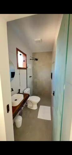 a bathroom with a toilet and a sink at Pousada Do Sol in Porto Seguro