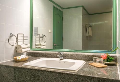 a bathroom with a sink and a large mirror at Krabi Maritime Resort in Krabi town