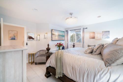 a bedroom with a large bed and a window at Luxury Oceanfront Condo with Private Beach Access in Oceanside
