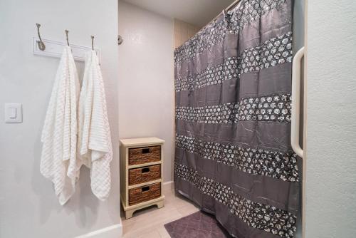 a bathroom with a shower with a shower curtain at Luxury Oceanfront Condo with Private Beach Access in Oceanside