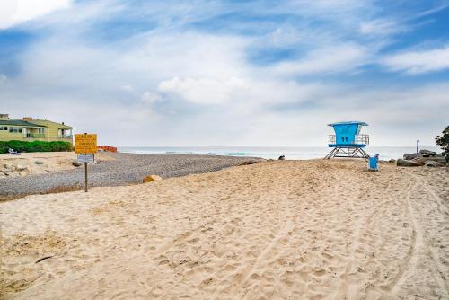 a blue lifeguard tower on a sandy beach at Luxury Oceanfront Condo with Private Beach Access in Oceanside