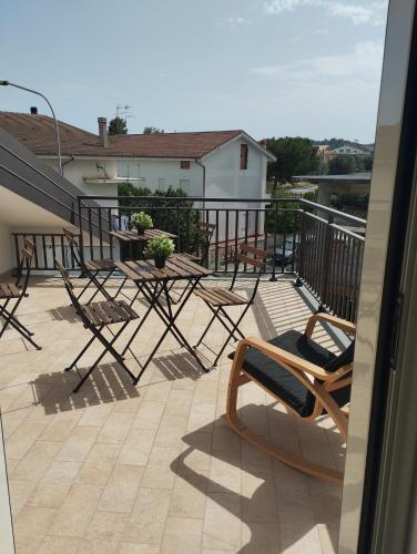 a balcony with chairs and a table on a building at Goccia di Mare monolocale in Roseto Capo Spulico