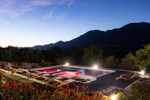 a villa with a swimming pool at night at Holiday Home Korda in Gruda