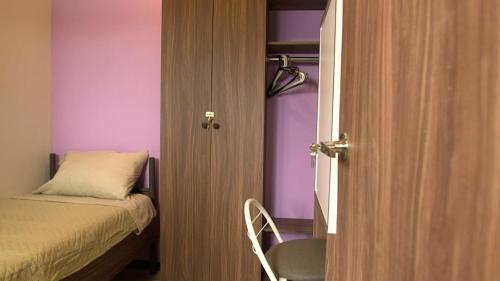 una piccola camera con un letto e una porta per una camera da letto di hostal confort Iztapalapa hospedaje económico y cómodo en cdmx a Città del Messico