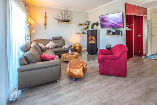 a living room with a couch and two chairs at Ostsee - Appartement Nr 151 "Hamborger Veermaster" im Strand Resort in Heiligenhafen