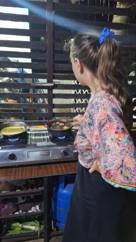 a young girl standing in a kitchen preparing food at Malabar home stay in Jaffna