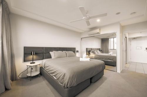 a bedroom with two beds and a ceiling fan at Boutique Hamilton Stay Portside in Brisbane