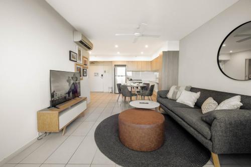 a living room with a couch and a table at Boutique Hamilton Stay Portside in Brisbane