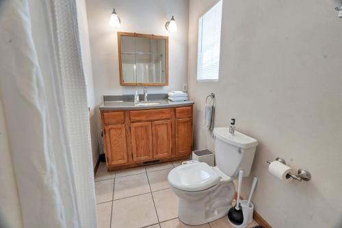 a bathroom with a toilet and a sink at SMART Home close to downtown, MSU, and more in Springfield
