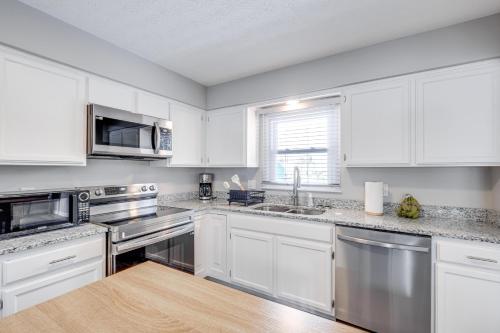 a kitchen with white cabinets and stainless steel appliances at 3 Mi to Cuyahoga Valley NP Fairlawn Family Home! in Fairlawn
