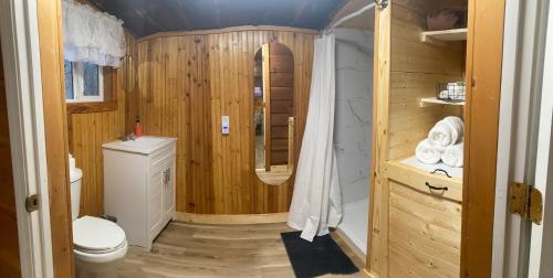 a small bathroom with a toilet and a shower at Sleepy Bear Cabin, Red River Gorge, KY, River Access & Views in Stanton