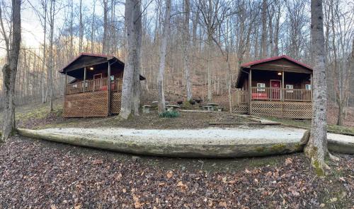 a couple of cabins in the woods with trees at Sleepy Bear Cabin, Red River Gorge, KY, River Access & Views in Stanton