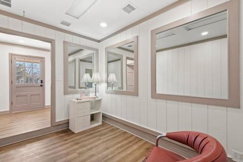 a living room with a red chair and a mirror at Jarrett Farm Resort - Suite 11 in Ramona