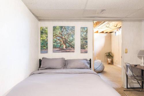 a bedroom with a bed and two windows at Semi Finished Basement with Pvt Bath Pvt Living Rm and pull out couch in Livonia