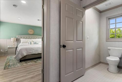 a bedroom with a bed and a toilet and a window at The Harmony at Jarrett Farm Resort in Ramona