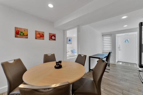 a dining room with a wooden table and chairs at Fire and Fun Luxe Stay w Pool Hot Tub and Game Room in Linden