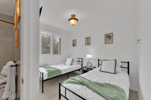 a bedroom with two beds and a window at Fire and Fun Luxe Stay w Pool Hot Tub and Game Room in Linden